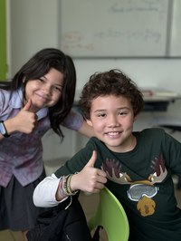 two students doing ok with hands