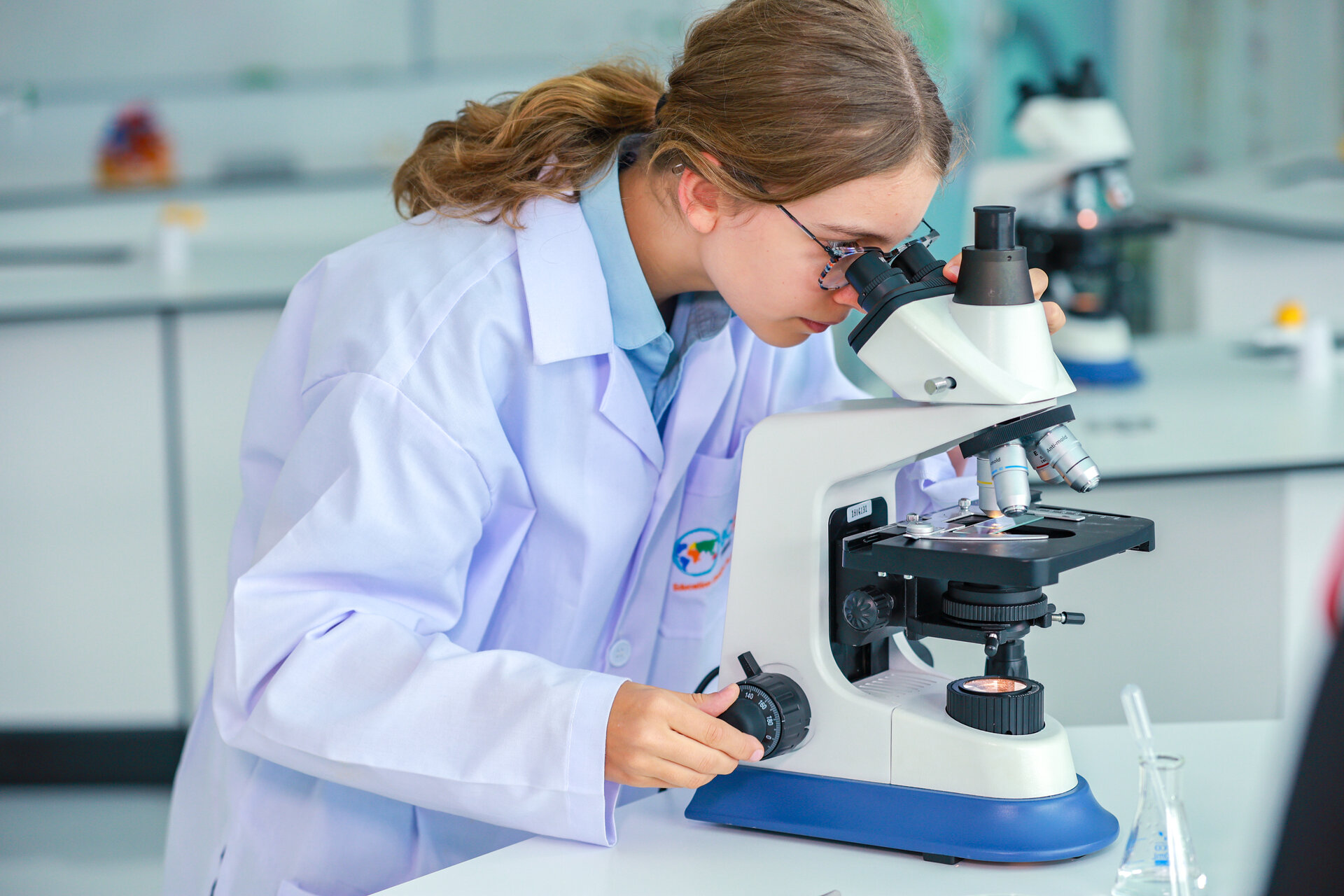 student at the microscope