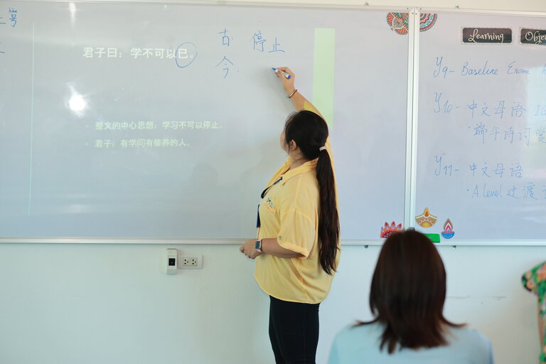 teacher writing at the whiteboard