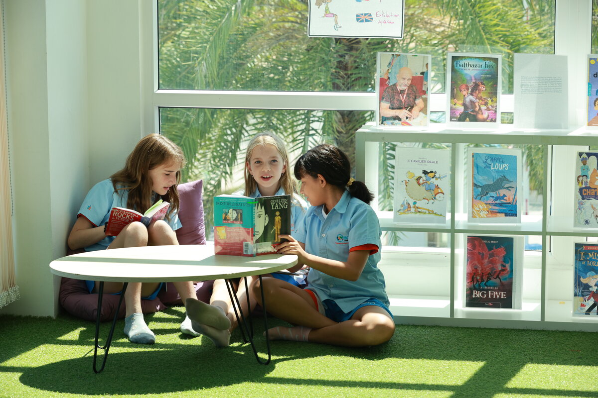 three students reading books