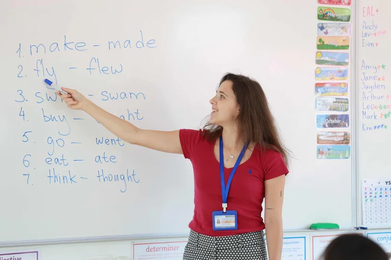 teacher pointing the whiteboard