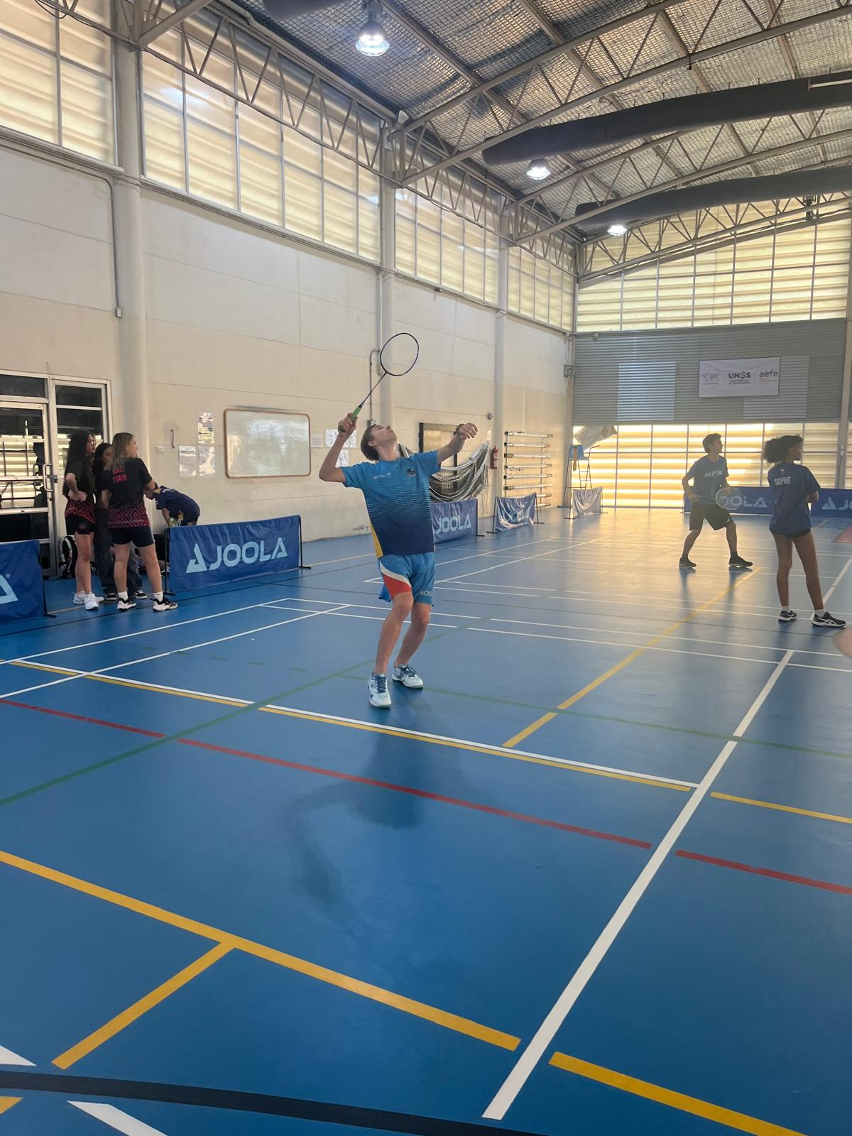 student plays badminton