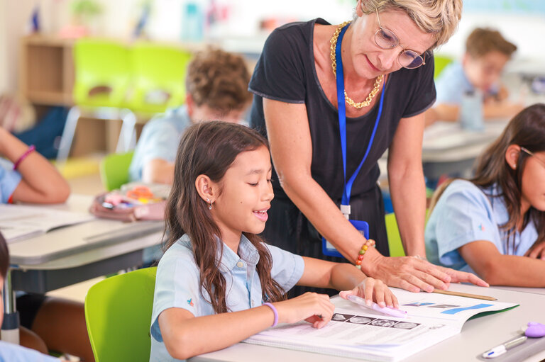 student reading with the teacher