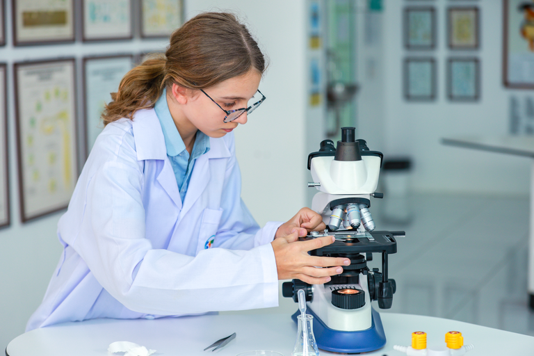 student at the microscope