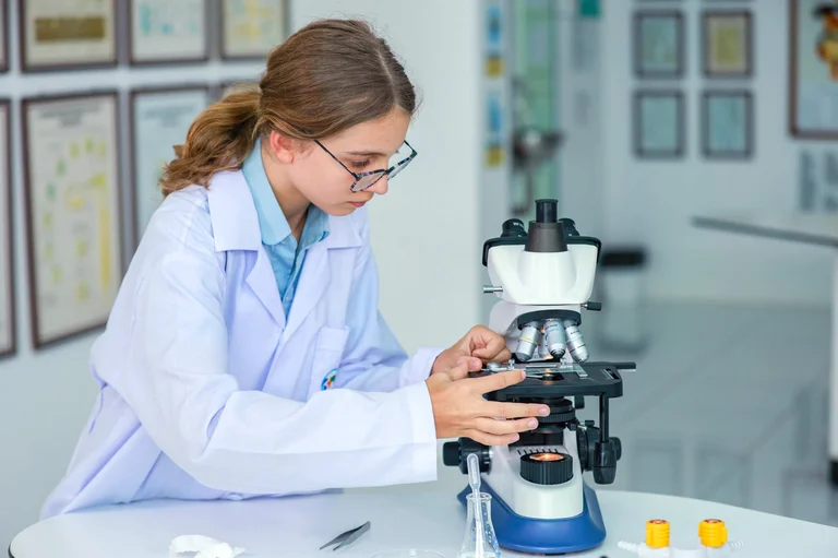 student at the microscope