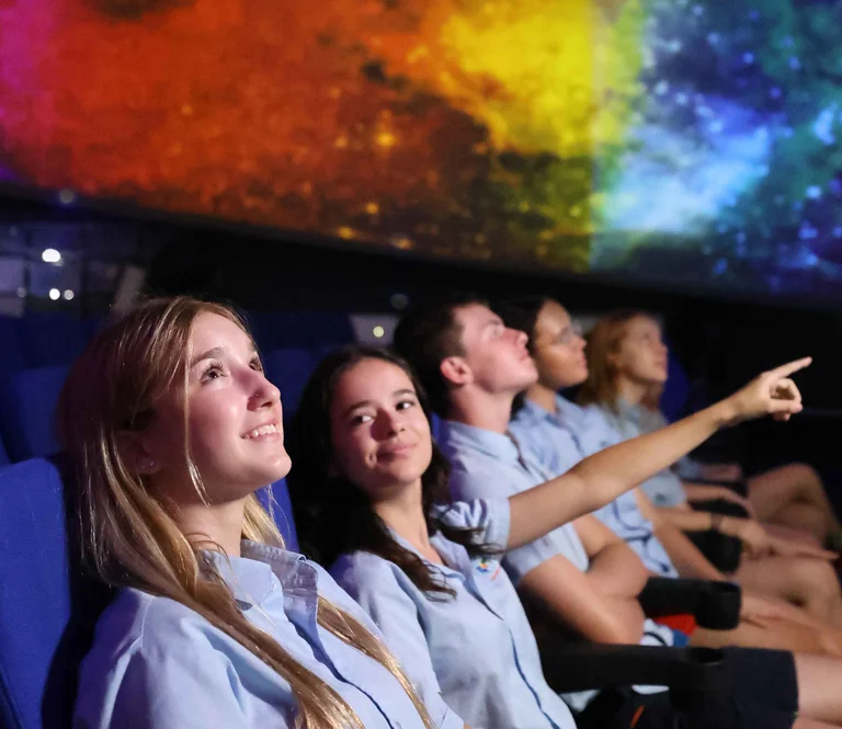 student under a coloured sky