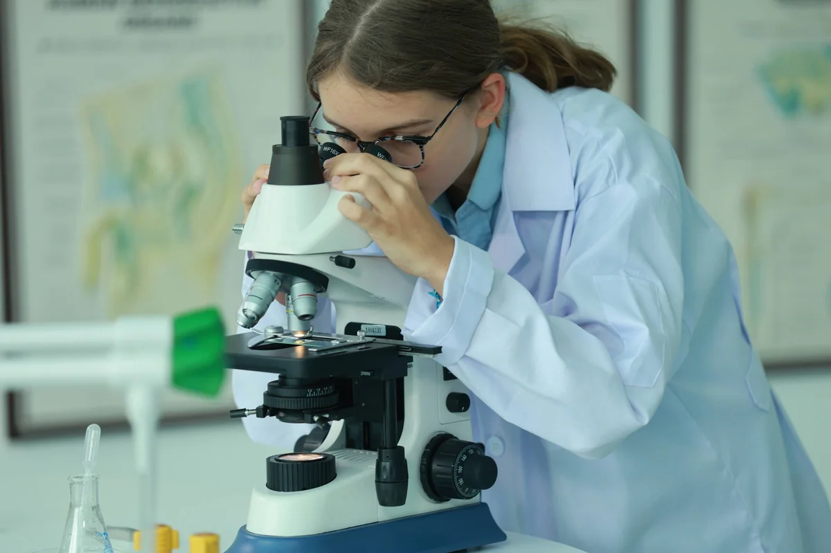 student at the microscope
