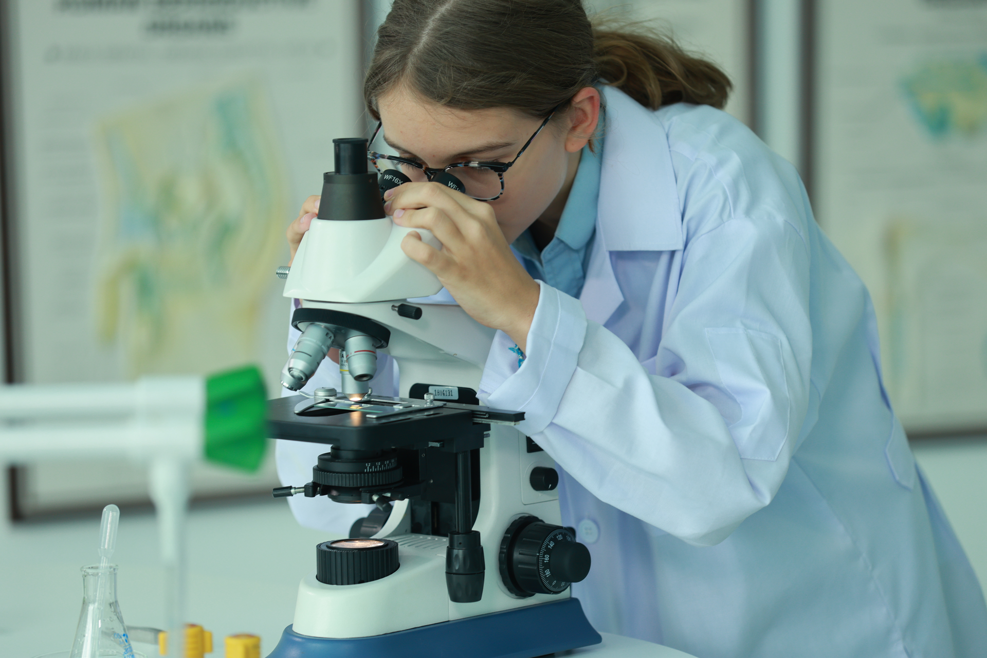 student at the microscope