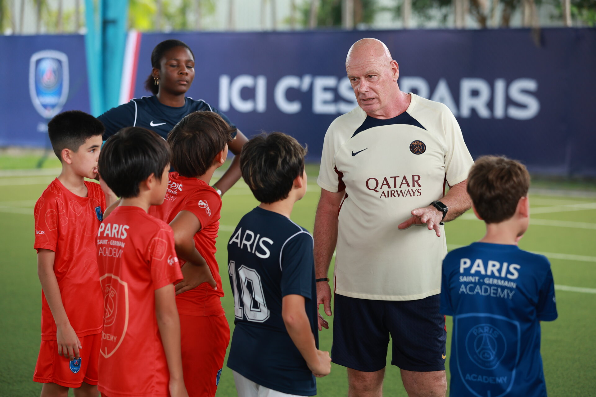 students with referee during football match