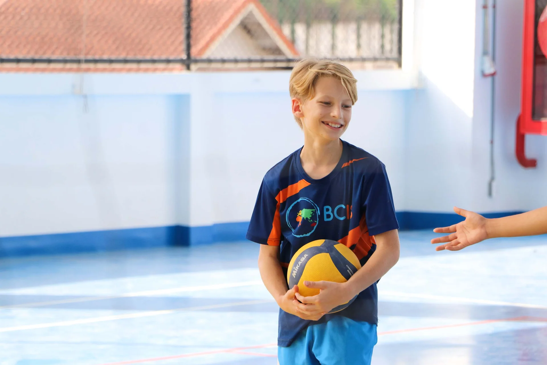 student holding a ball 